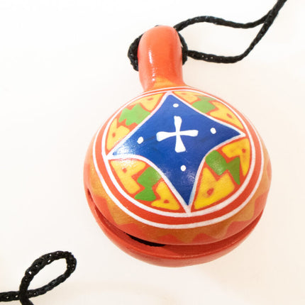 red jingle bell on cord