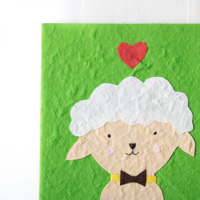 cream sheep on green card