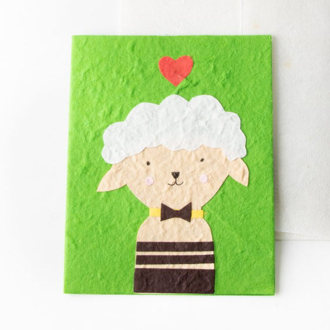 cream sheep on green card